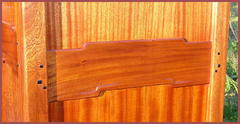 Detail of relief carved "cloud lift" design and Ebony pegs on the side of the cabinet.